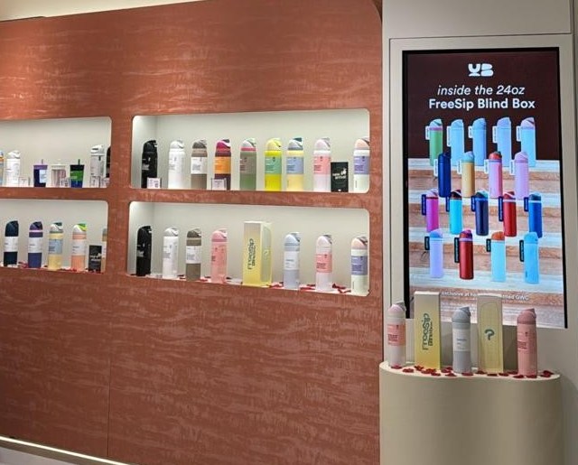 Retail store display wall with drink bottles
