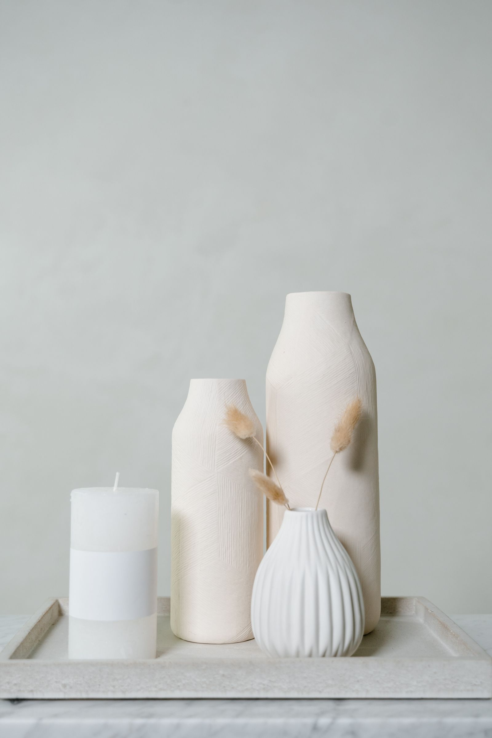 Calm ceramic vessels on a neutral shelf